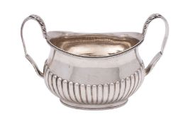 A Victorian silver twin-handled sugar basin of oval boat-shaped outline,