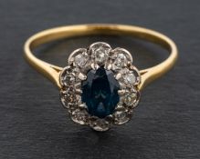 An oval, mixed-cut, synthetic sapphire and single-cut diamond cluster ring,