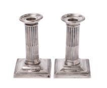 A pair of George V silver desk candlesticks, makers Thomas Bradbury & Sons,