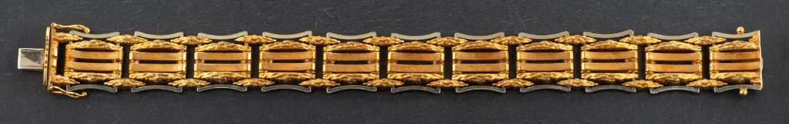 A 1970's, 18ct, bi-colour gold, textured, fancy-link bracelet, with import marks for London, 1970,