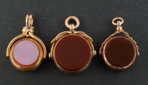 Three swivel fobs, including two 9ct gold,
