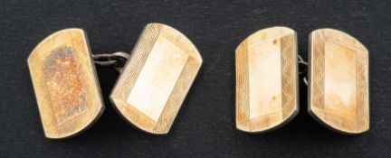 A pair of rounded, rectangular cufflinks, with engine-turned decoration, stamped '9CT' and 'SILVER',