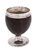A white metal mounted pedestal coconut cup with monogram to lip,