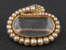 A Georgian locket brooch, designed as a pearl-set snake surrounding a glazed compartment,