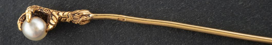 A pearl tie-pin designed as an eagle's claw, diameter of pearl ca. 4.