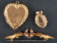 Two locket pendants and a brooch, including a heart-shaped locket pendant with foliate engraving,