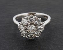 A round, brilliant-cut diamond cluster ring, engraved diamond weight 1.