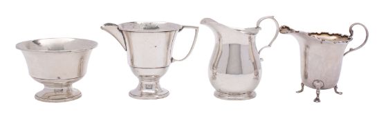 A George V silver cream jug, makers William Hutton & Sons Ltd, Sheffield 1932 of pear shape,