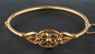 An Edwardian, 9ct gold, openwork, hinged bangle, of foliate design,