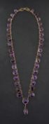 A late 19th/ early 20th century, spectacle-set, mixed-cut amethyst necklace,