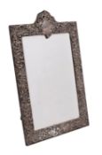 An Edward VII silver easel mirror, maker Henry Matthews, Birmingham, 1907 of arched outline,