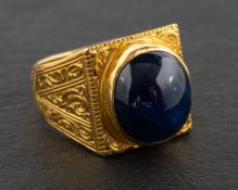 A cabochon-cut sapphire ring, estimated sapphire weight ca. 7cts, length of ring head ca. 1.