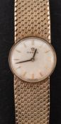 Omega, a ladies 9ct gold wristwatch the dial with raised baton numerals,