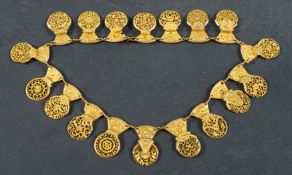 A necklace of early 19th century, gilded brass watch cocks, total length ca. 44.