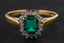 An 18ct gold, emerald-cut synthetic emerald and single-cut diamond cluster ring,