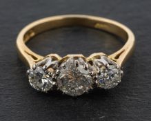 An 18ct gold, round, brilliant-cut diamond, three-stone ring, total estimated diamond weight ca.