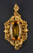 An oval, mixed-cut citrine pendant, with foliate and floral surround, estimated citrine weight ca.