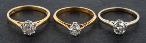 Three diamond, single-stone rings, including a round, brilliant-cut diamond ring,