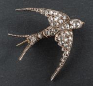 A late 19th/ early 20th century, rose-cut diamond and cabochon-cut ruby swallow brooch,