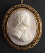 A coral cameo brooch/ pendant, possibly depicting Shakespeare in profile, with cannetille surround,