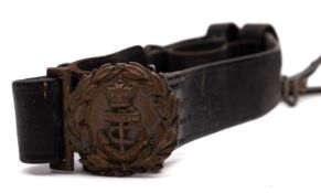 A late 19th century Royal Navy regulation black leather waist belt: the clasp with Queen's Crown.