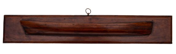 A 19th century mahogany half block model of a skiff: the hull constructed in seven layers on a