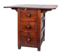 A mahogany cabin table: the fold down top raised on a central pedestal fitted three short drawers,