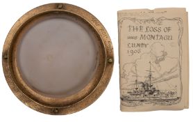 A circular brass bulkhead light from the Royal Navy Duncan-class battleship HMS 'Montagu':
