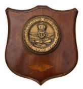 A George V brass and mahogany Ward Room Badge for RNAS Training Establishment Cranwell,