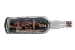 A WWII German Prisoner of War model ship in a bottle: set on a waterline base with lighthouse and