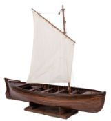 A scale model of a gaff rigged jolly boat: set sails over plank and pinned hull with fixtures and