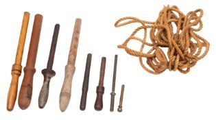 A group of various belaying pins: comprising an iron example and three wooden pins,