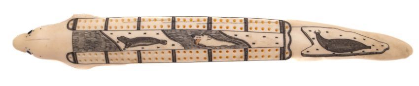 An Inuit scrimshaw cribbage board in the form of a seal: having carved seal's head to one end and