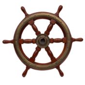 A small teak and brass ship's helm: central brass boss with six block and turned spars and brass
