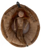 An early 20th century SS Devon souvenir in the form of a mermaid seated in a life preserver: