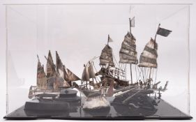 A group of four Continental and Chinese silver and white-metal model boats: comprising a junk set