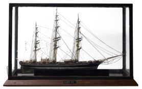 A cased scale model of the Cutty Sark standing and running rigged over decks with lifeboats,