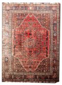An Afghanistan carpet, the rose stepped and serrated hexagonal field with a central pole medallion,