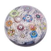 A dated Perthshire spaced millefiori paperweight set with a figural cat and a dog cane and other