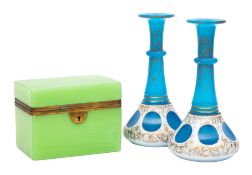 An opaline glass table casket and a pair of overlay glass bottles,