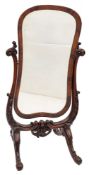A Victorian mahogany and stained beech swing frame cheval mirror of cartouche shape with inset