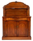 A Victorian mahogany chiffonier, arched back with turned supports,