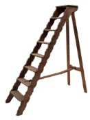 A set of late 19th century pine housekeeper's steps, with wavy edge supports, slop tread,