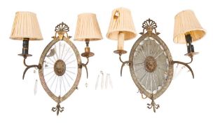 A pair of 19th century gilt metal girandoles with oval mirrored backplates centered with an oval