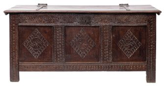 A 17th century oak coffer, with hinged cover above a frieze of anthemia filled arches,