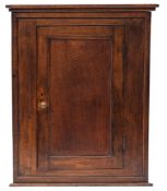 A George III oak hanging corner cupboard,