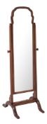 A Georgian style walnut mirror on a cheval frame, 136cm high x 36cm wide.