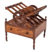 A late Regency mahogany four division music canterbury with X-frame divisions and carved laurel