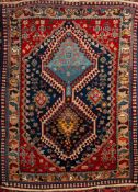 A Quashgai rug, the indigo field with twin hooked hexagonal medallions,