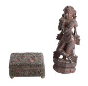 A Chinese lacquer cased enamel box and an Indian hardwood carving of a deity the box carved with a